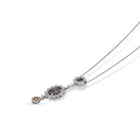 1.84 Fancy deep Orangy Brown Oval-cut diamond 0.09 fancy orange pear shape-cut diamond 1.20 white diamonds 18K white gold