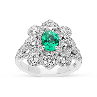 Oval Cut Green Emerald Birthstone Ring Featuring a Diamond Pave Flower Setting